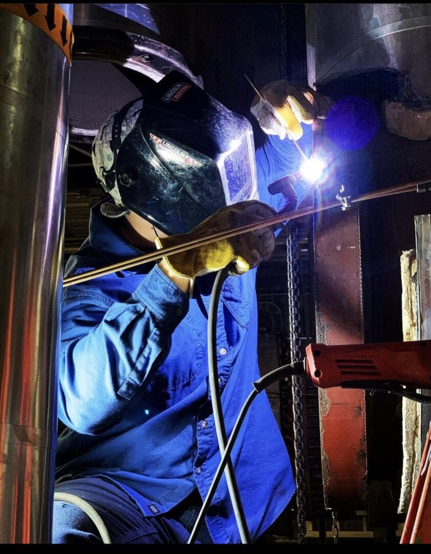 TIG welder repairing stainless steel heat exchanger for industrial facility by Rocket Shop LLC